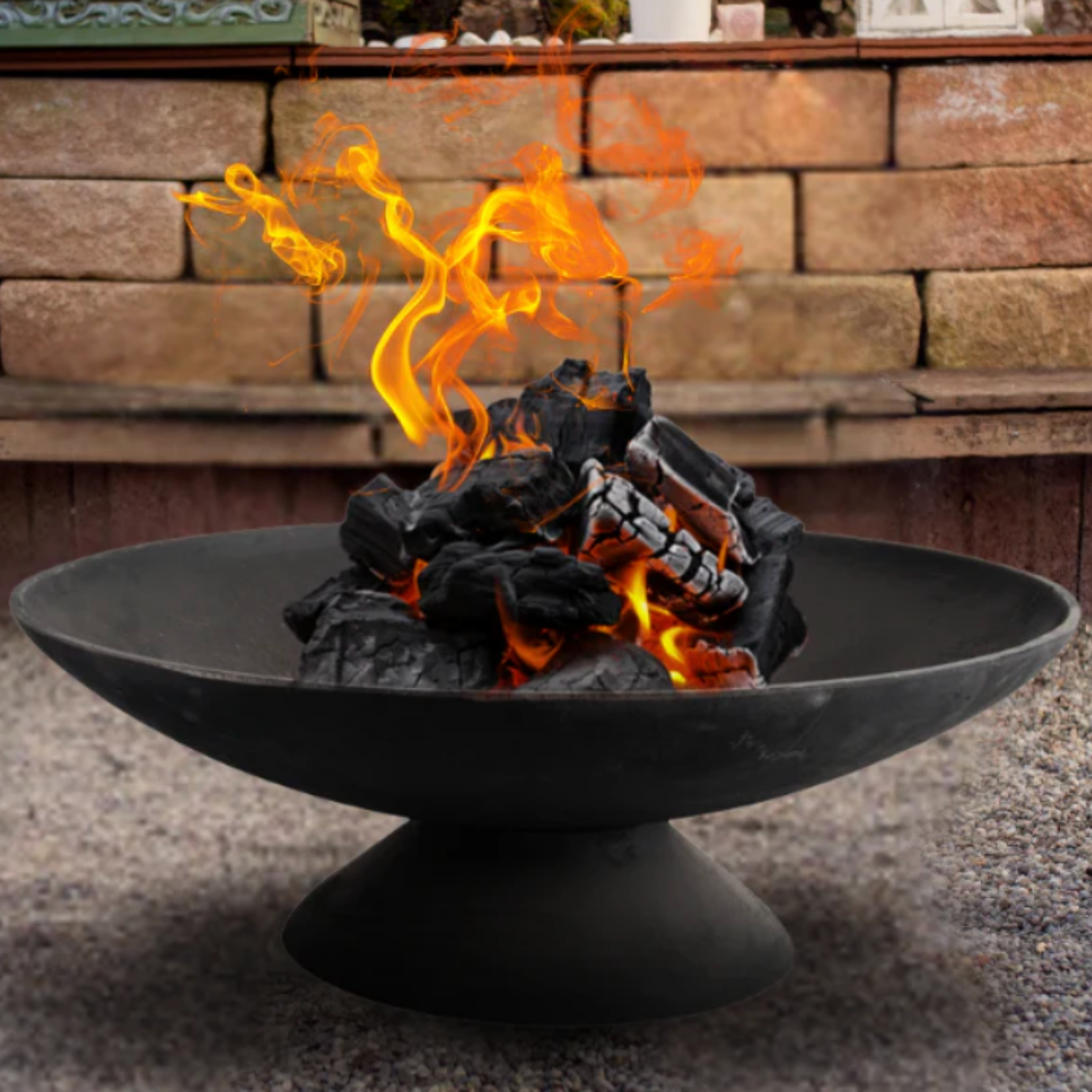 black fire put with wood on fire with brick background