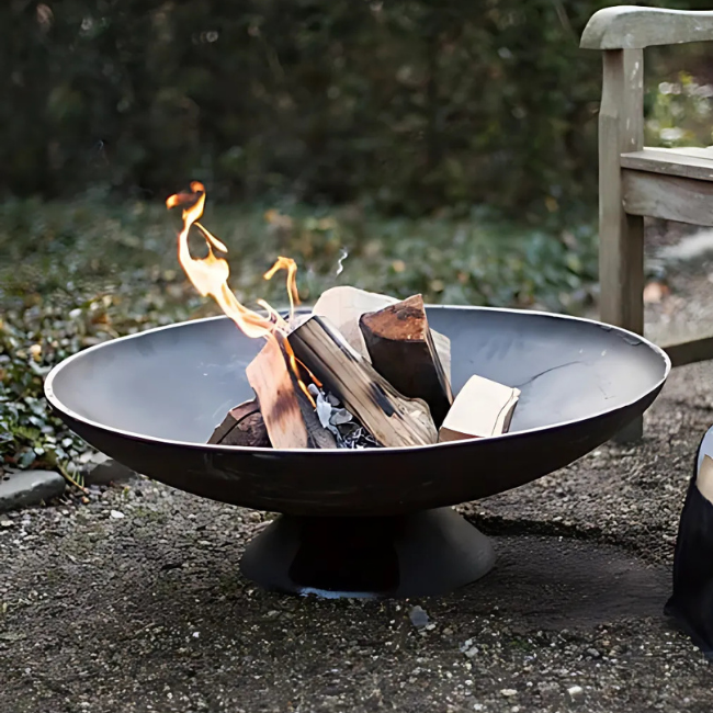 Close-up of a black cast iron fire pit showcasing its durable design and rustic appearance