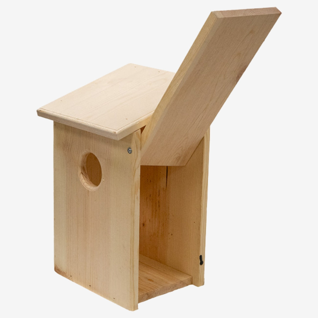 Prime Retreat cedar bird shelter mounted outdoors, ideal for screech owls, saw-whet owls, and kestrels, with natural wood design for nesting and weather resistance.