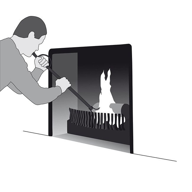A person is using the Blaze Booster Fire Blowpipe to boost the flames in a fireplace. The tool helps revive embers and maintain fire combustion effectively and safely.